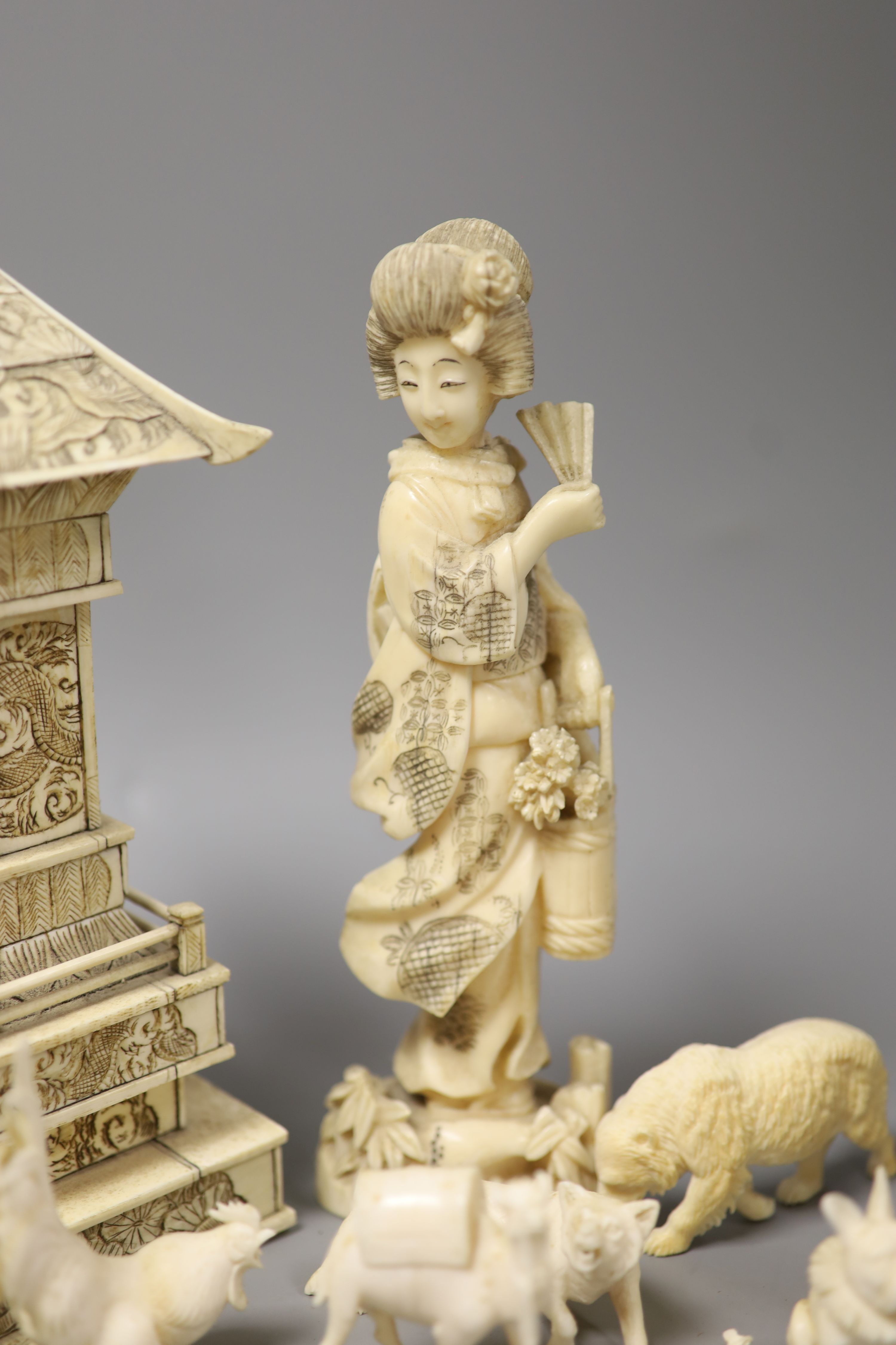 A Japanese Ivory model of a bijin, a similar model of a temple, various European Ivory models of animals and birds, an Indian Ivory figure et cetera, or late 19th or early 20th century